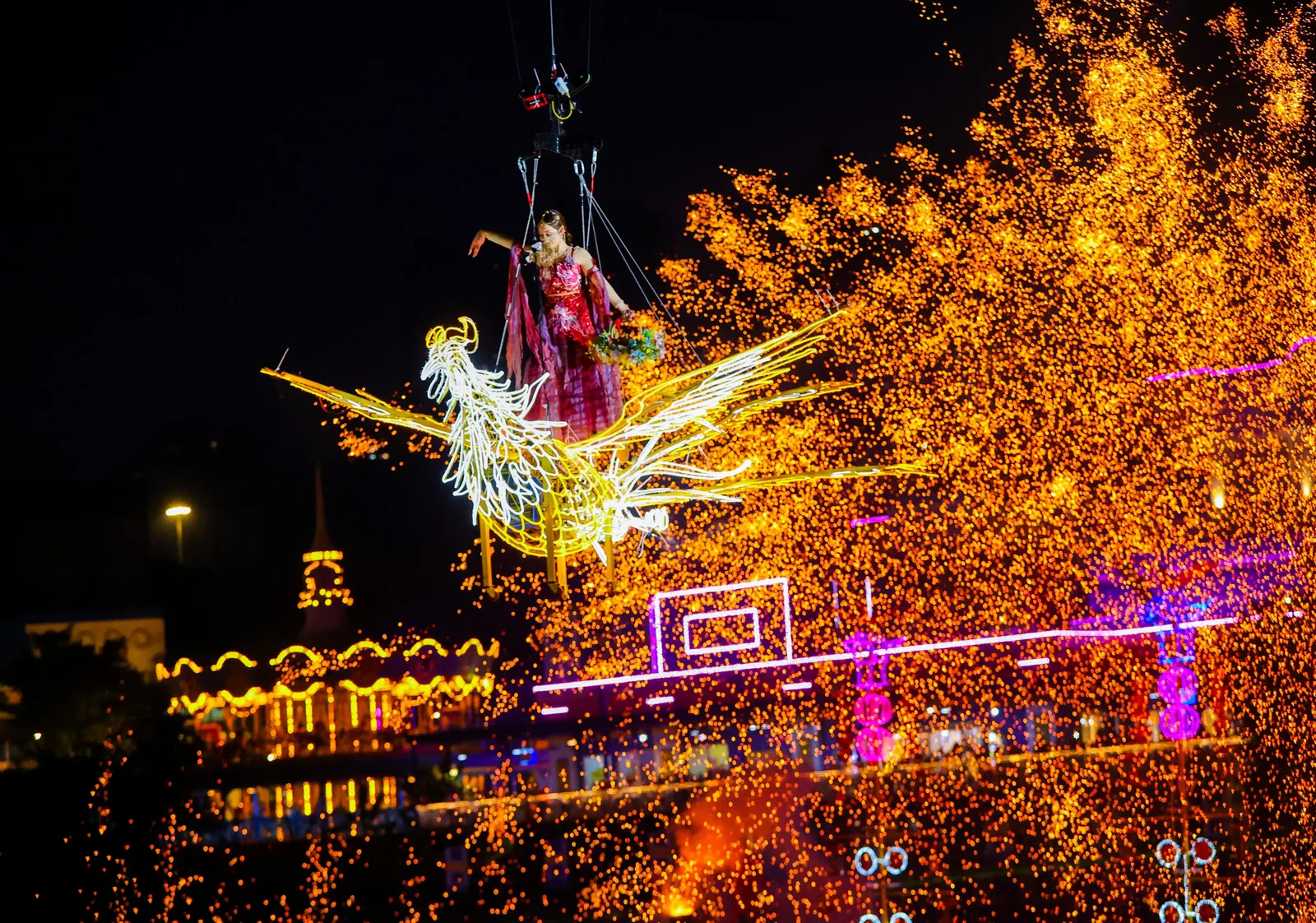 A woman in classical dress performing during the fireworks show