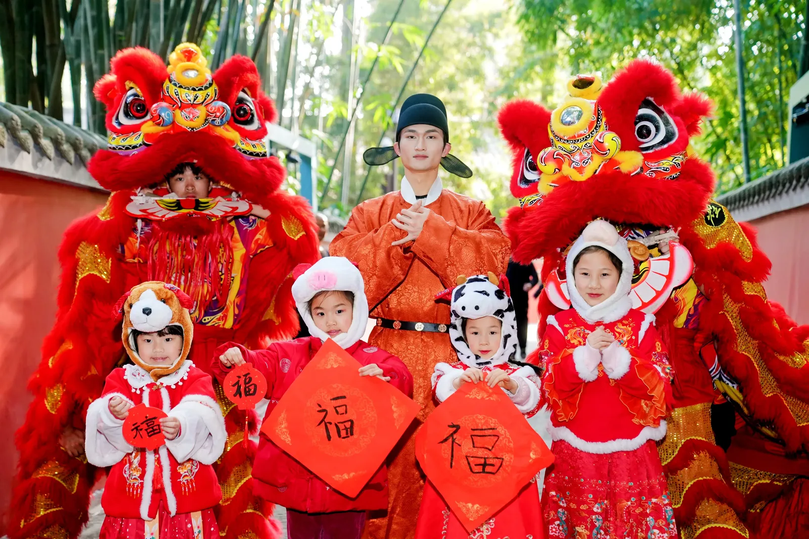 Children in festive new-year clothes with traditional lion dancers