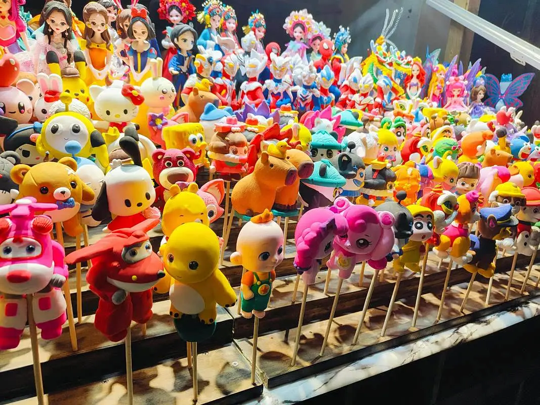 New-year market toys and dolls laid out in rows
